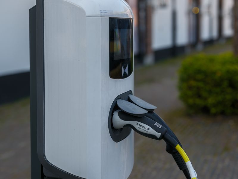 A Type 2 EV charging connector and cable at a charging point